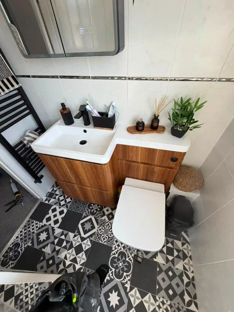 Newly fitted WC and cupboard with basin and taps